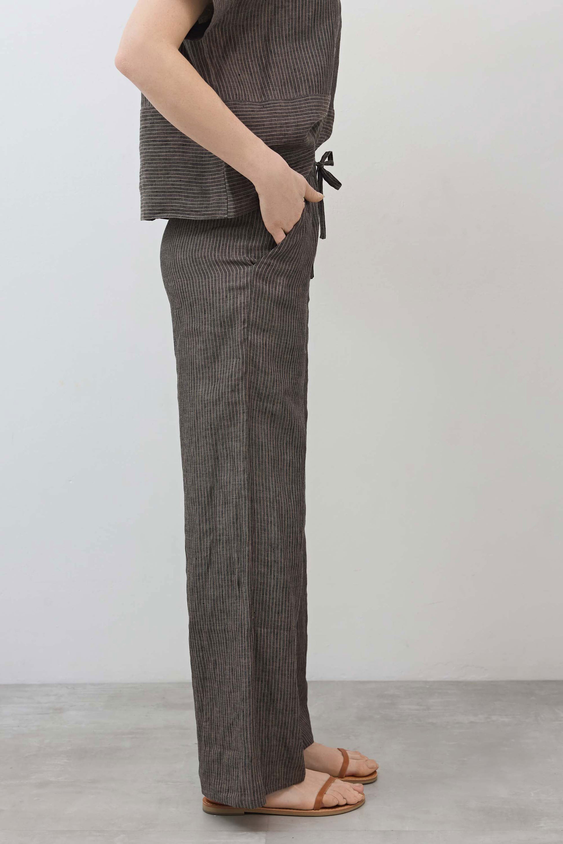Charcoal pinstripe linen wide-leg pants with ankle-length wide legs and ties