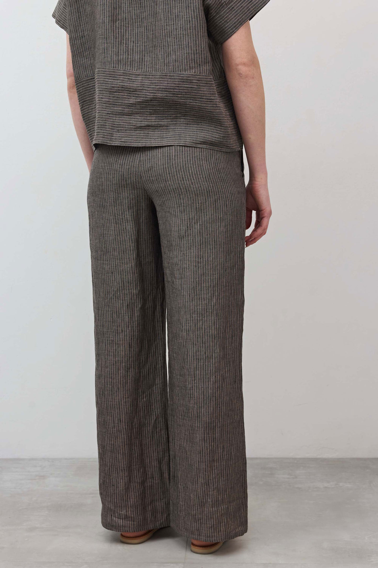 Charcoal pinstripe wide-leg linen pants with pull-on waist and relaxed leg