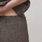 Charcoal pinstripe linen pants fabric with front seam and drawstring waist