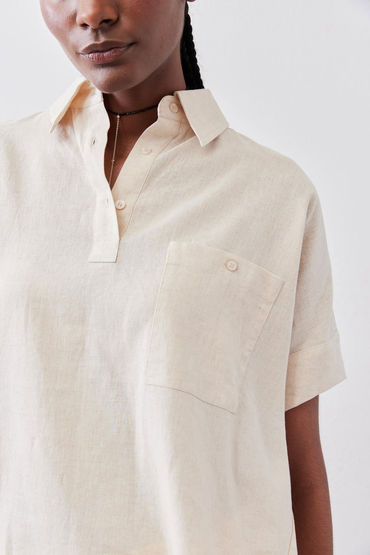 Oat linen short-sleeve blouse close-up of collar, button placket, and chest pocket