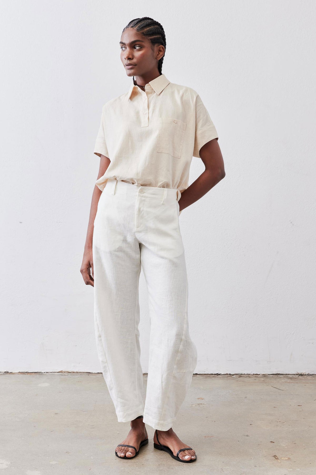 Oat linen short-sleeve blouse, half-button placket and chest pocket, worn with pants
