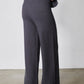 Charcoal wide-leg lounge pants with sneakers, full-length view