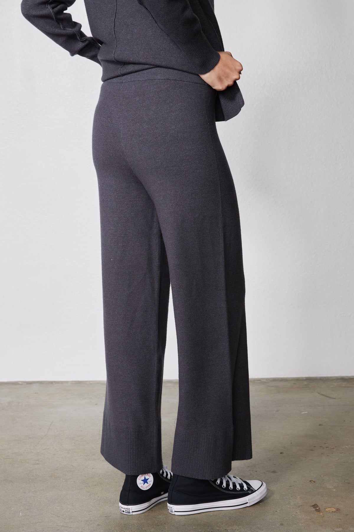 Charcoal wide-leg lounge pants with sneakers, full-length view