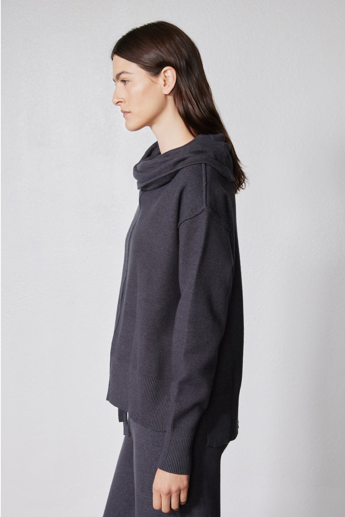 Charcoal oversized cowl hoodie top over wide-leg lounge pants, side view