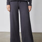 Charcoal wide-leg lounge pants with drawstring, paired with cowl hoodie sleeves