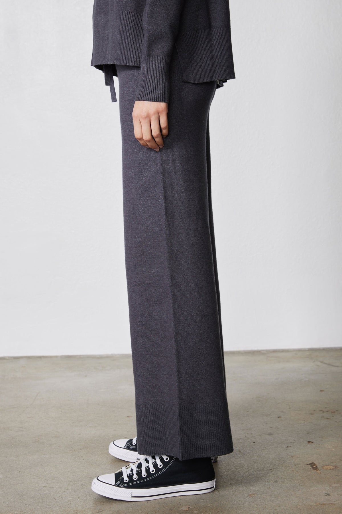 Charcoal wide-leg lounge pants with drawstring and low-top sneakers