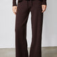 Chocolate plum wide-leg drawstring pants with sneakers, full lower-body view