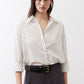 White oversized tunic shirt with small black dot pattern, button-front collar and long sleeves
