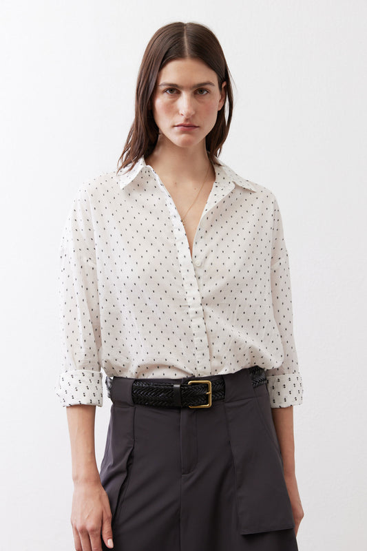 White oversized tunic shirt with small black dot pattern, button-front collar and long sleeves