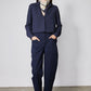Navy long-sleeve blouse with high collar and front placket, belted waist