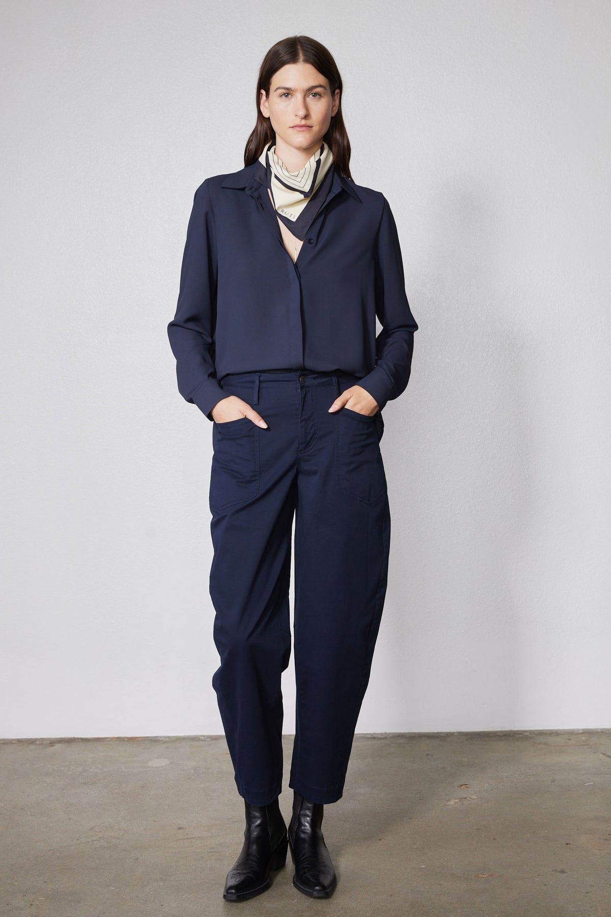 Navy long-sleeve blouse with high collar and front placket, belted waist