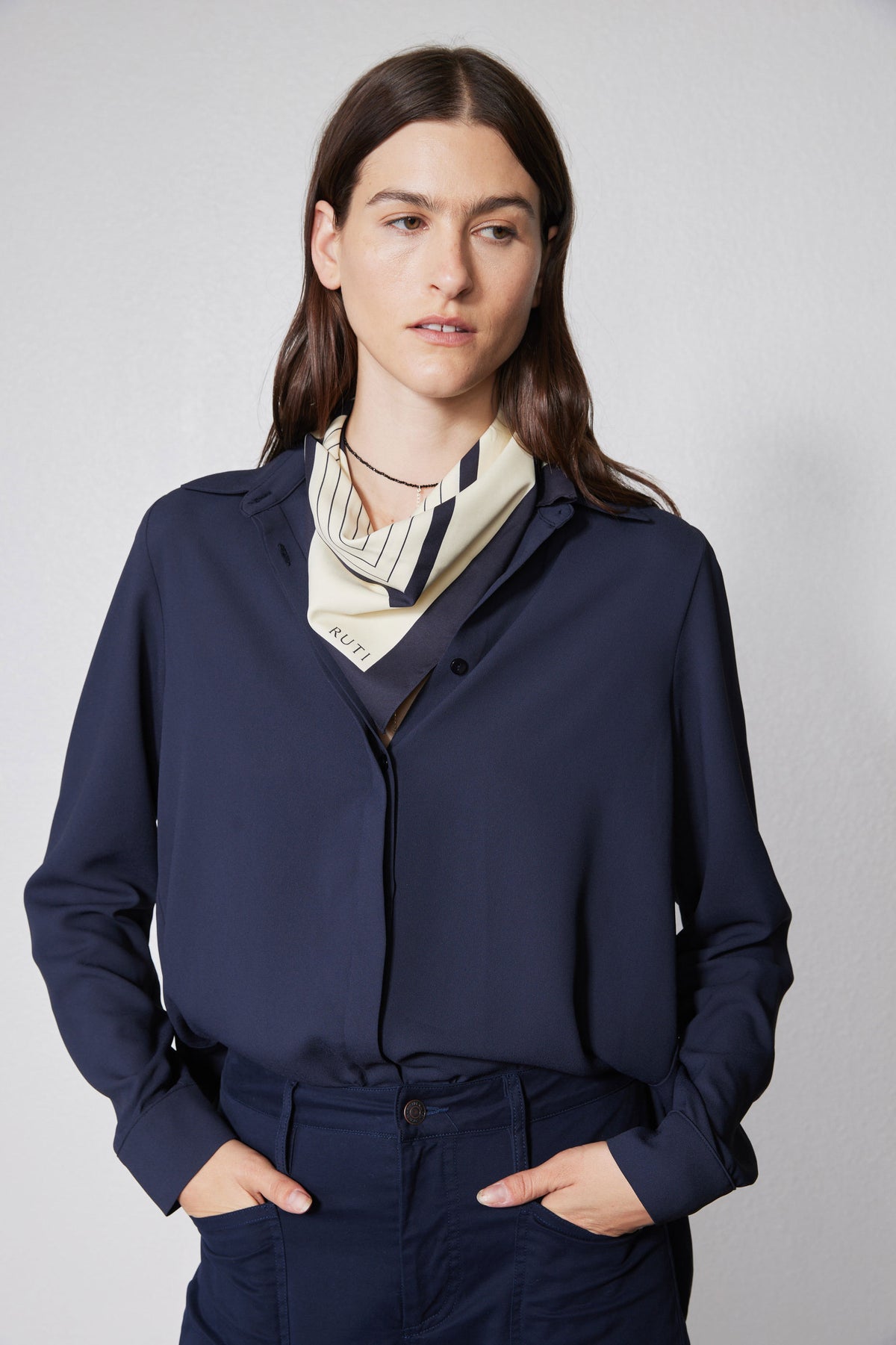 Navy long-sleeve blouse with high collar, zippered front, cuffed sleeves