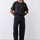 Black relaxed cargo barrel pants with cargo pockets and buttoned cuffs