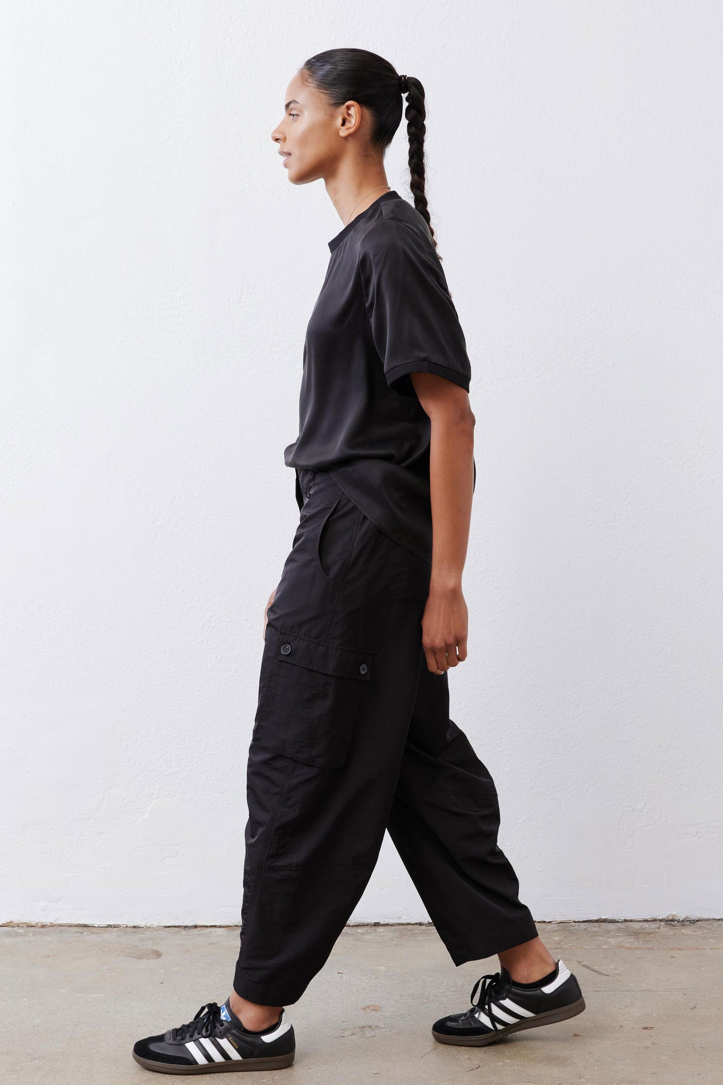 Black cargo barrel pants with side cargo pockets and relaxed straight legs