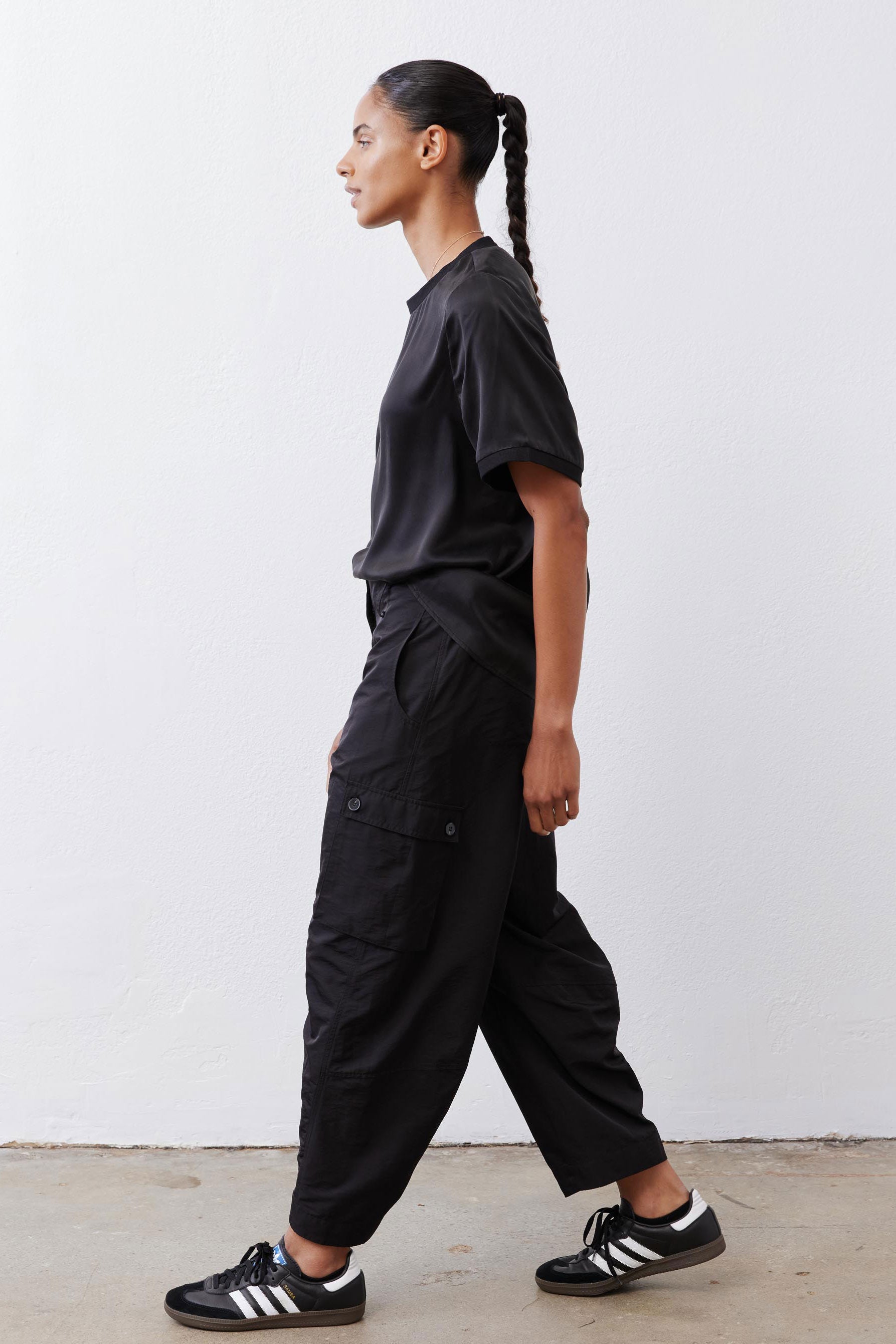 Black cargo barrel pants with side cargo pockets and relaxed straight legs