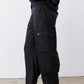 Black cargo barrel pants with flap pocket detail at the thigh and ankle cuffs