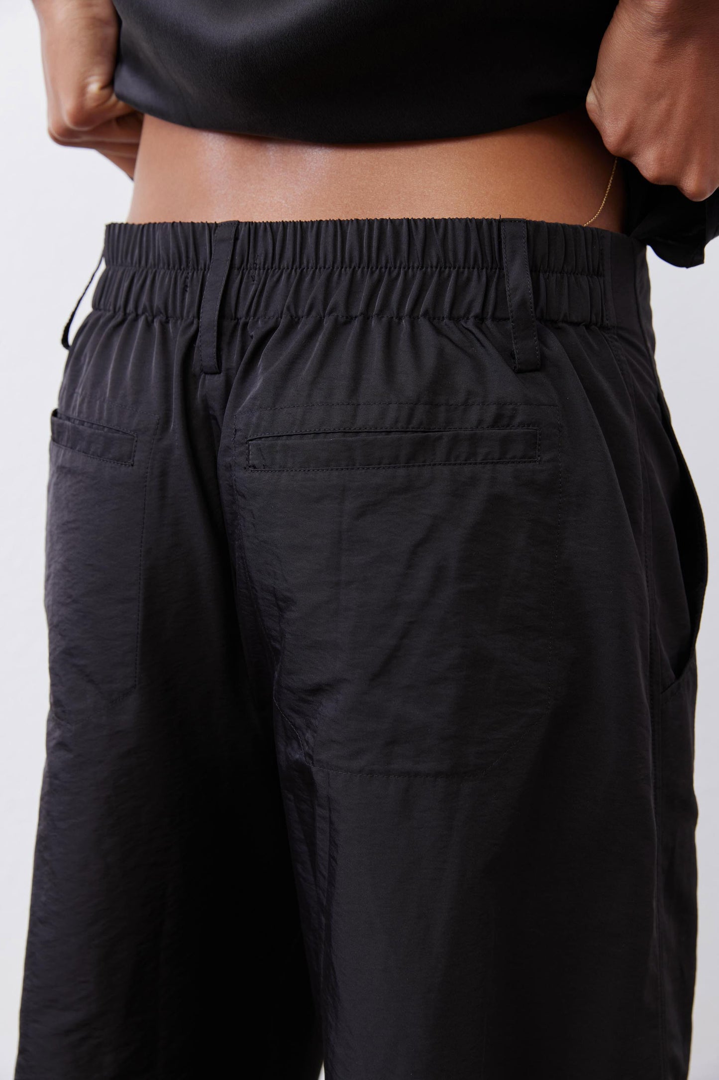 Black cargo barrel pants with elastic waistband and relaxed drape