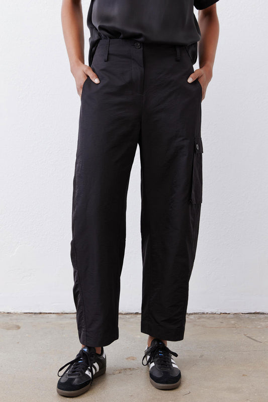 Black cargo barrel pants with cargo pocket panels and ankle-length relaxed fit