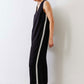Black relaxed wide-leg sleeveless jumpsuit with V-neck and white side stripe, side view