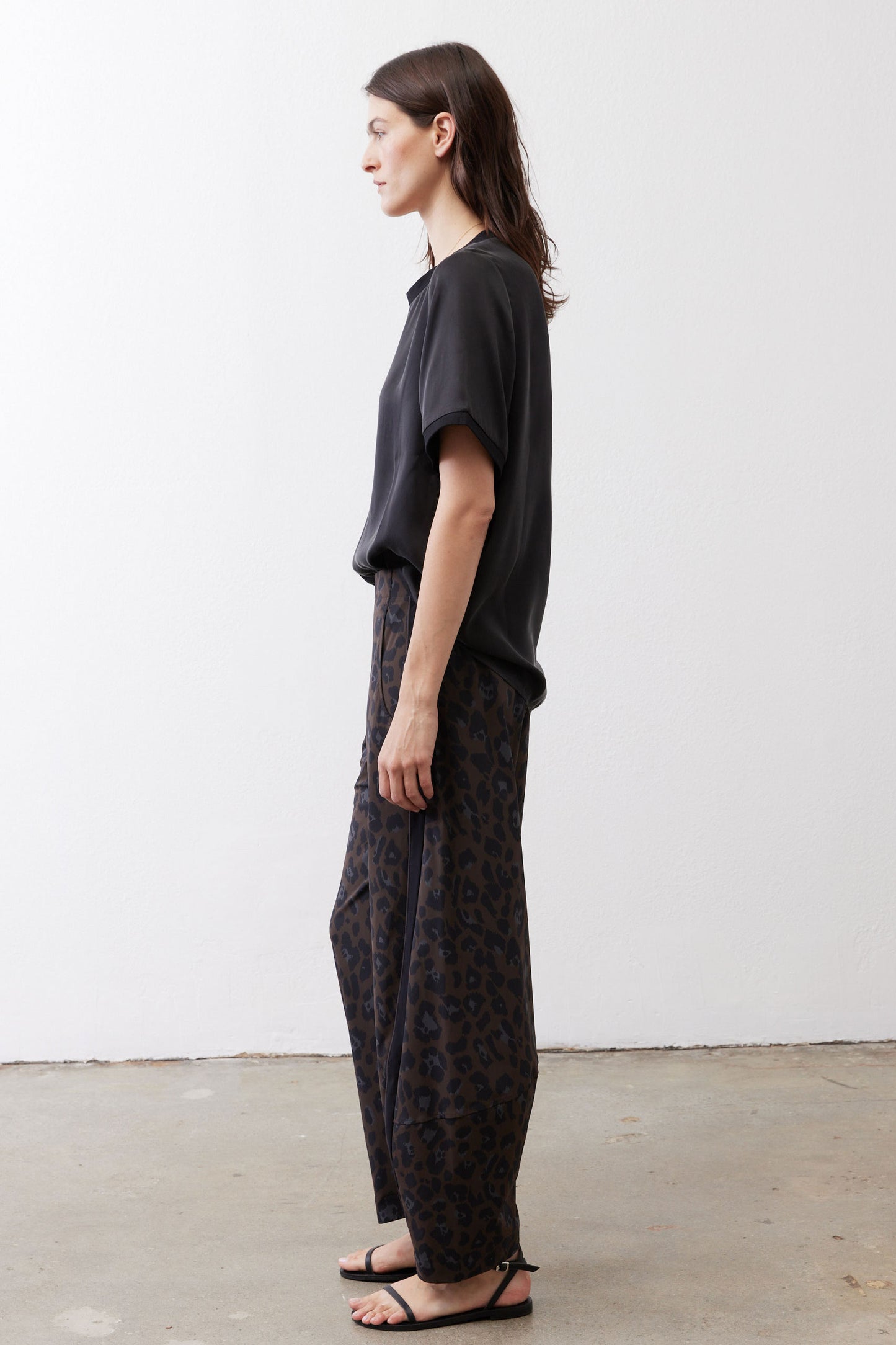 Black relaxed silk top, short sleeves, crew neck, side profile