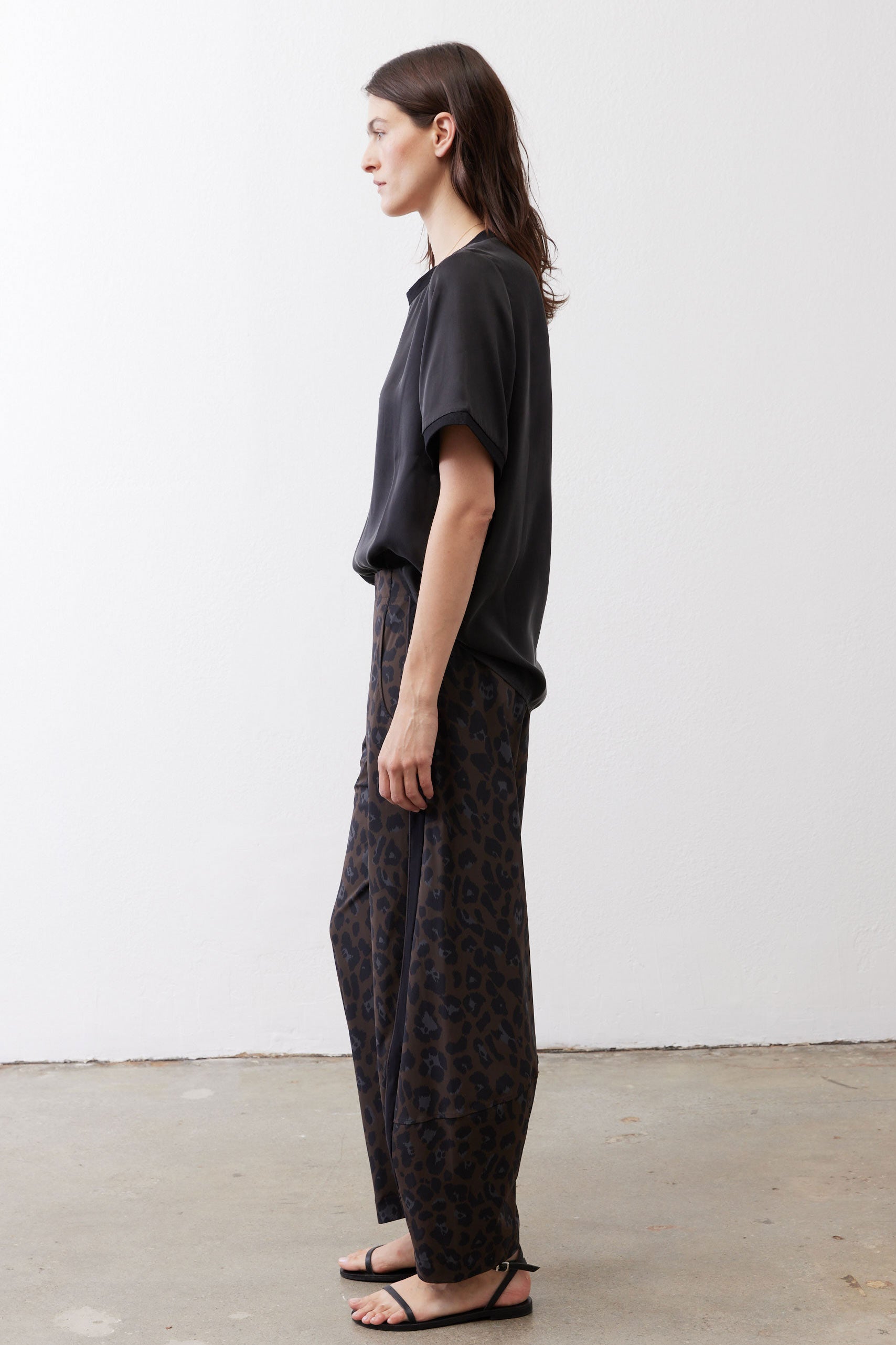 Black relaxed silk top, short sleeves, crew neck, side profile