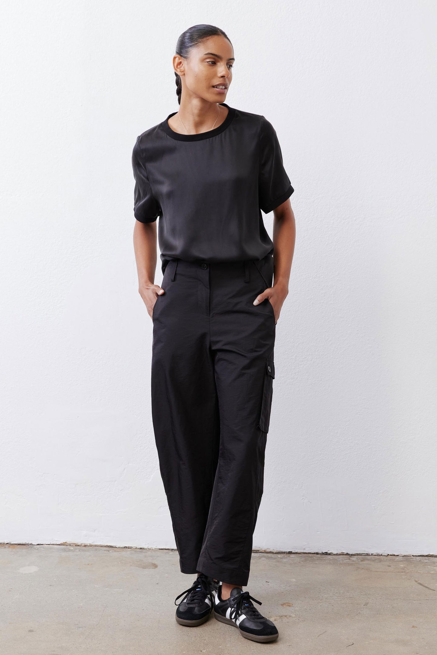 Black relaxed silk top with crew neck and short sleeves, straight hem
