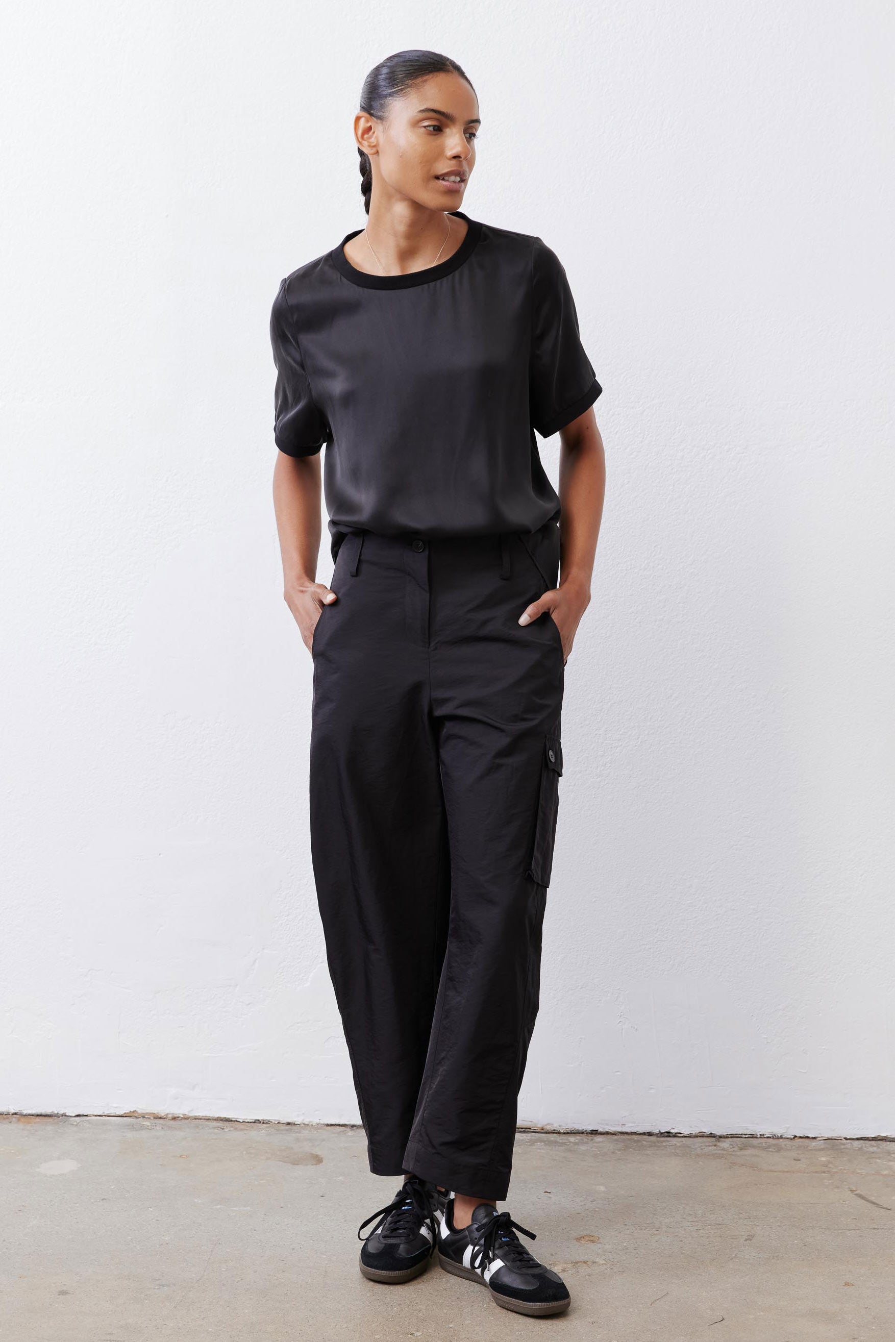 Black relaxed silk top with crew neck and short sleeves, straight hem