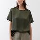 Relaxed forest green silk crew-neck top with short sleeves, front view