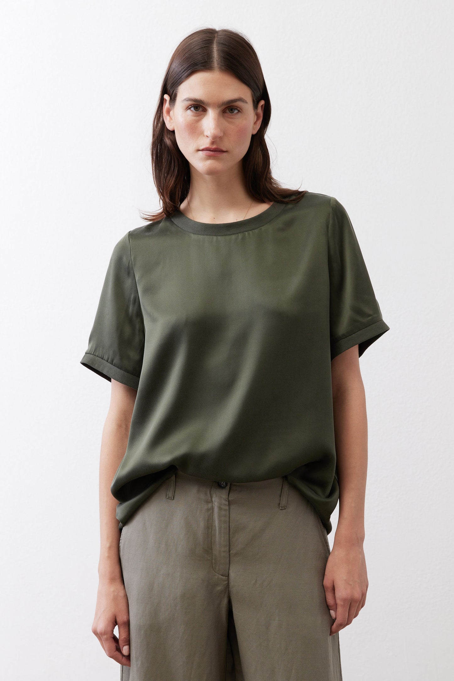 Relaxed forest green silk crew-neck top with short sleeves, front view