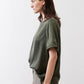 Relaxed forest green silk crew-neck top, side view, short sleeves