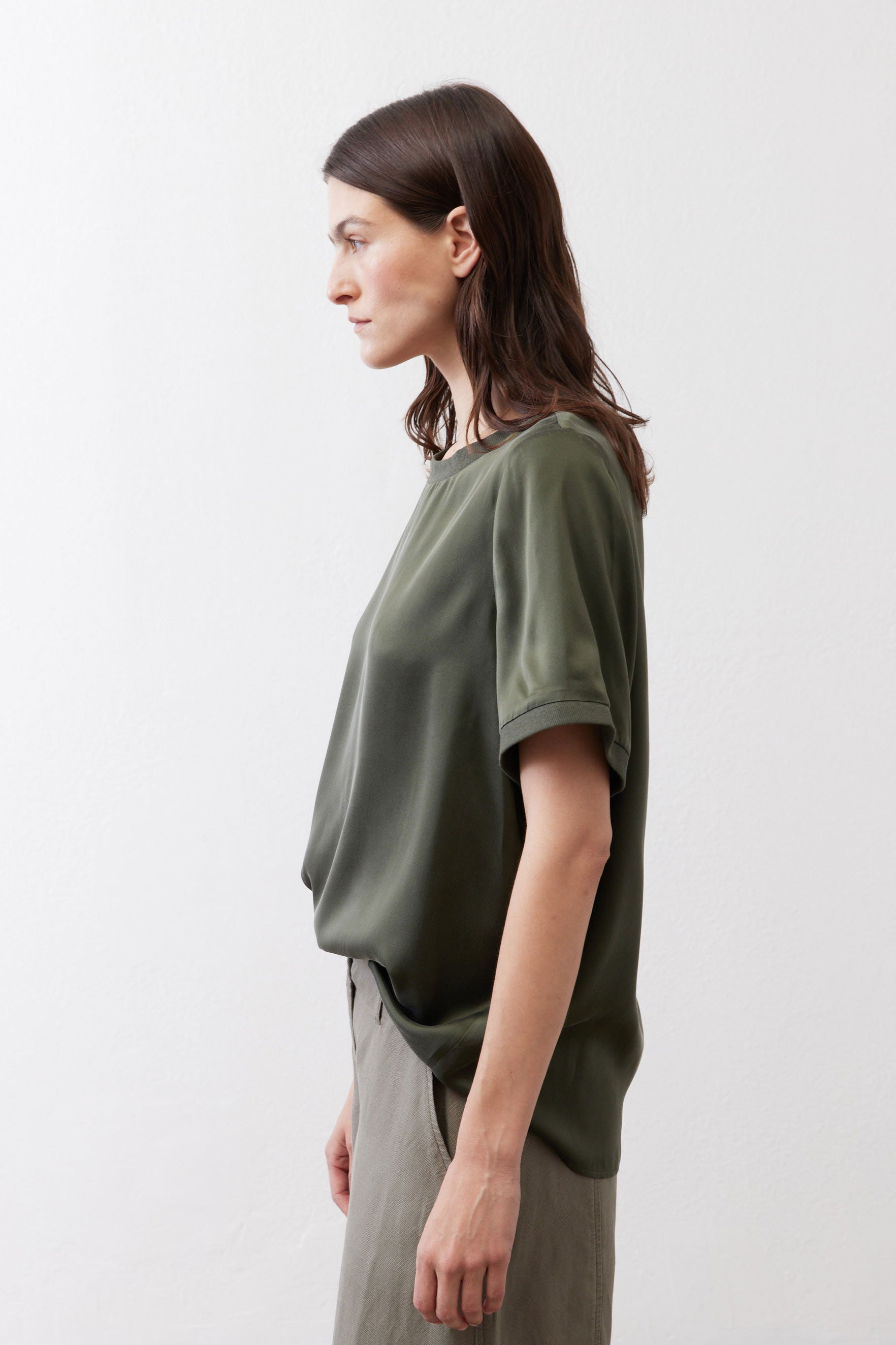 Relaxed forest green silk crew-neck top, side view, short sleeves