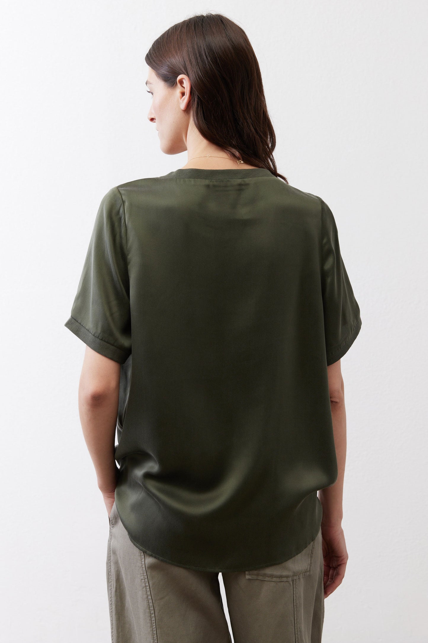 Relaxed forest green silk top, back view, short sleeves and crew neck