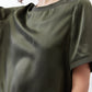 Forest green silk top close-up, smooth drape and crew neckline detail