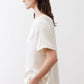 Ivory silk top with crew neck and short sleeves, side view