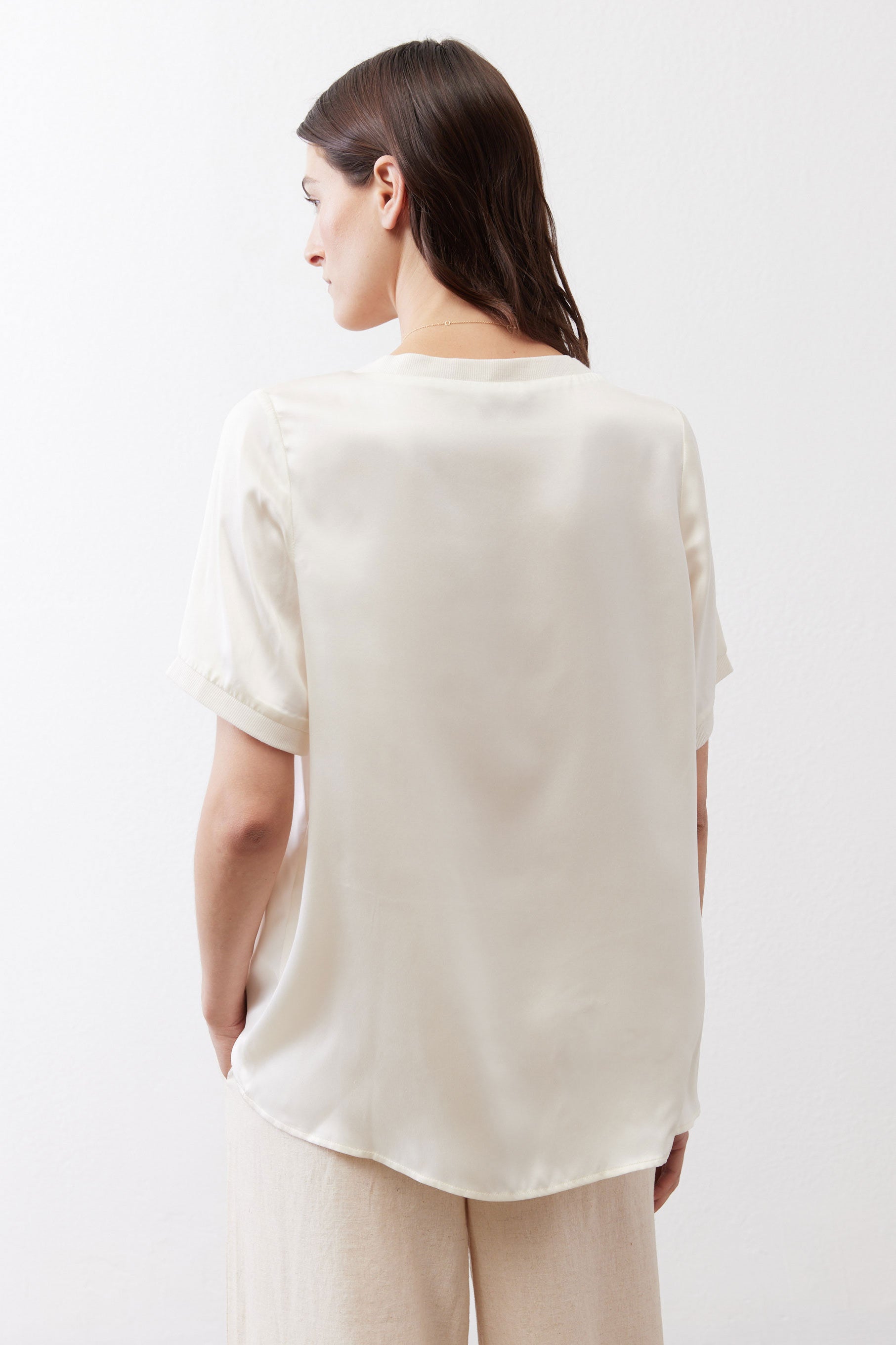 Ivory silk top back view with short sleeves and rounded crew neckline