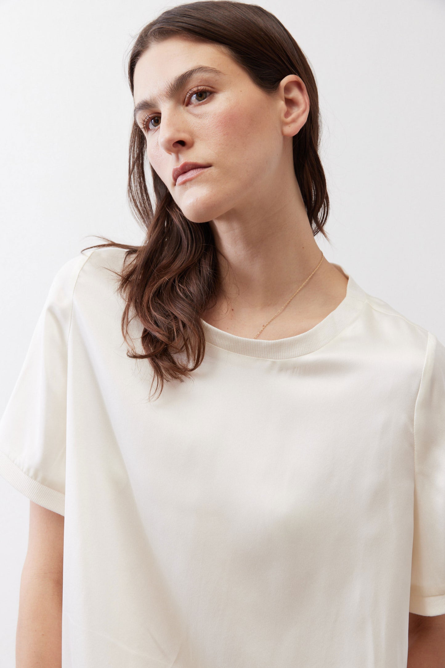 Ivory silk top close-up showing crew neck and short sleeves
