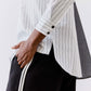 Striped button-down blouse with vertical light gray and white lines, button placket
