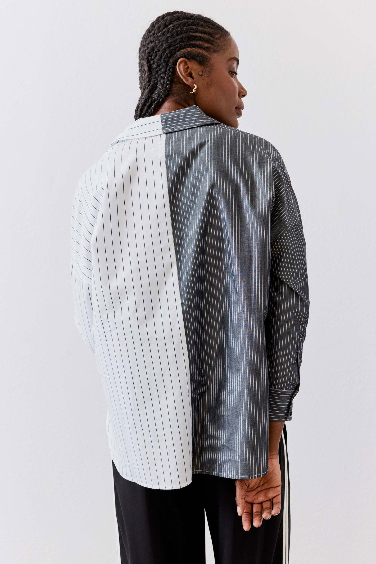 Striped button-down blouse back view with vertical gray-and-white stripes and hem vent