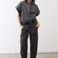 Gray striped button-up blouse with short sleeves worn with black pants
