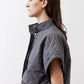 Gray striped button-up blouse with draped shoulder and short loose sleeves