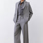 Gray-and-white striped button-down blouse collar peeking under gray jacket
