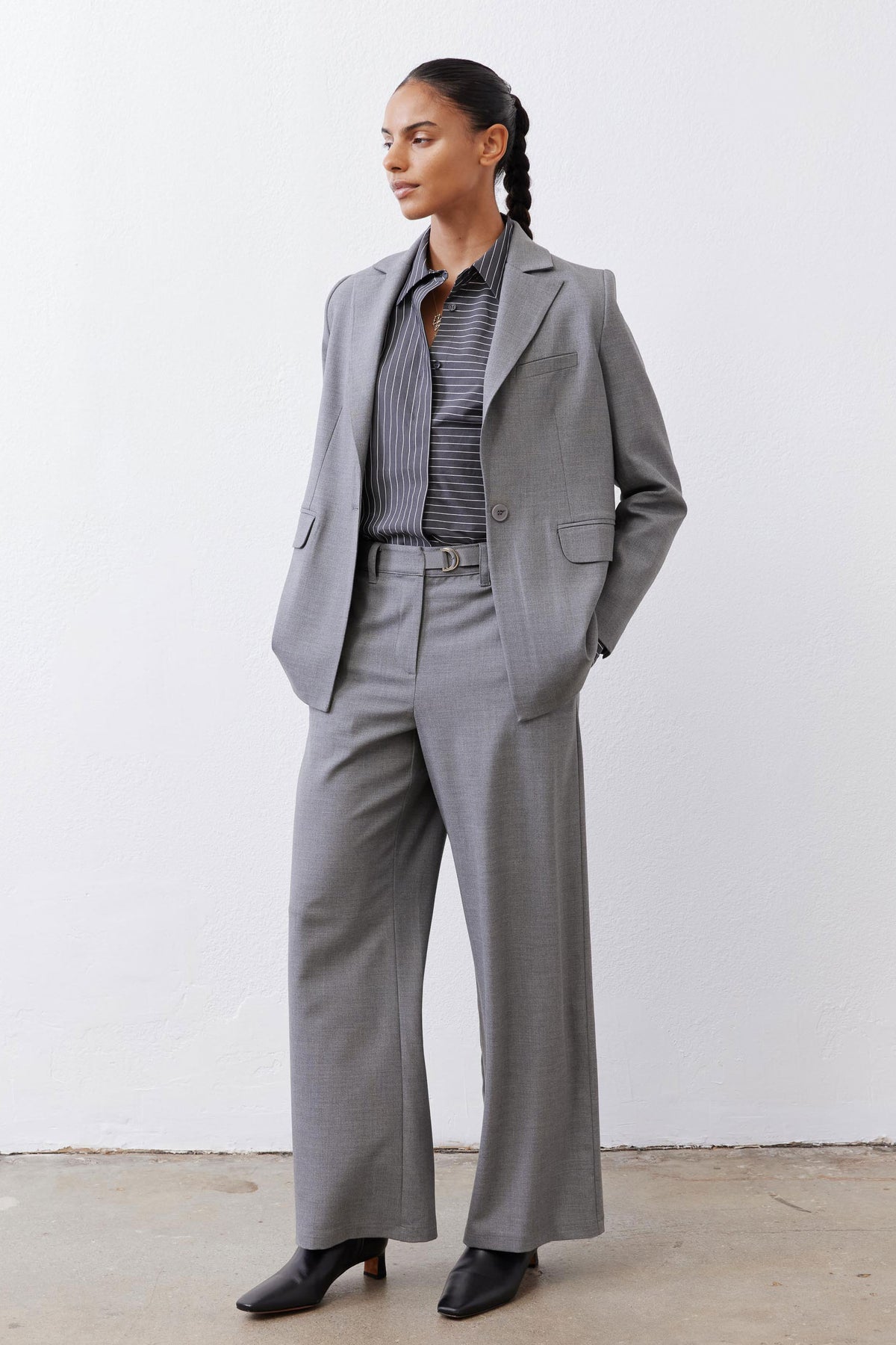 Gray-and-white striped button-down blouse collar peeking under gray jacket