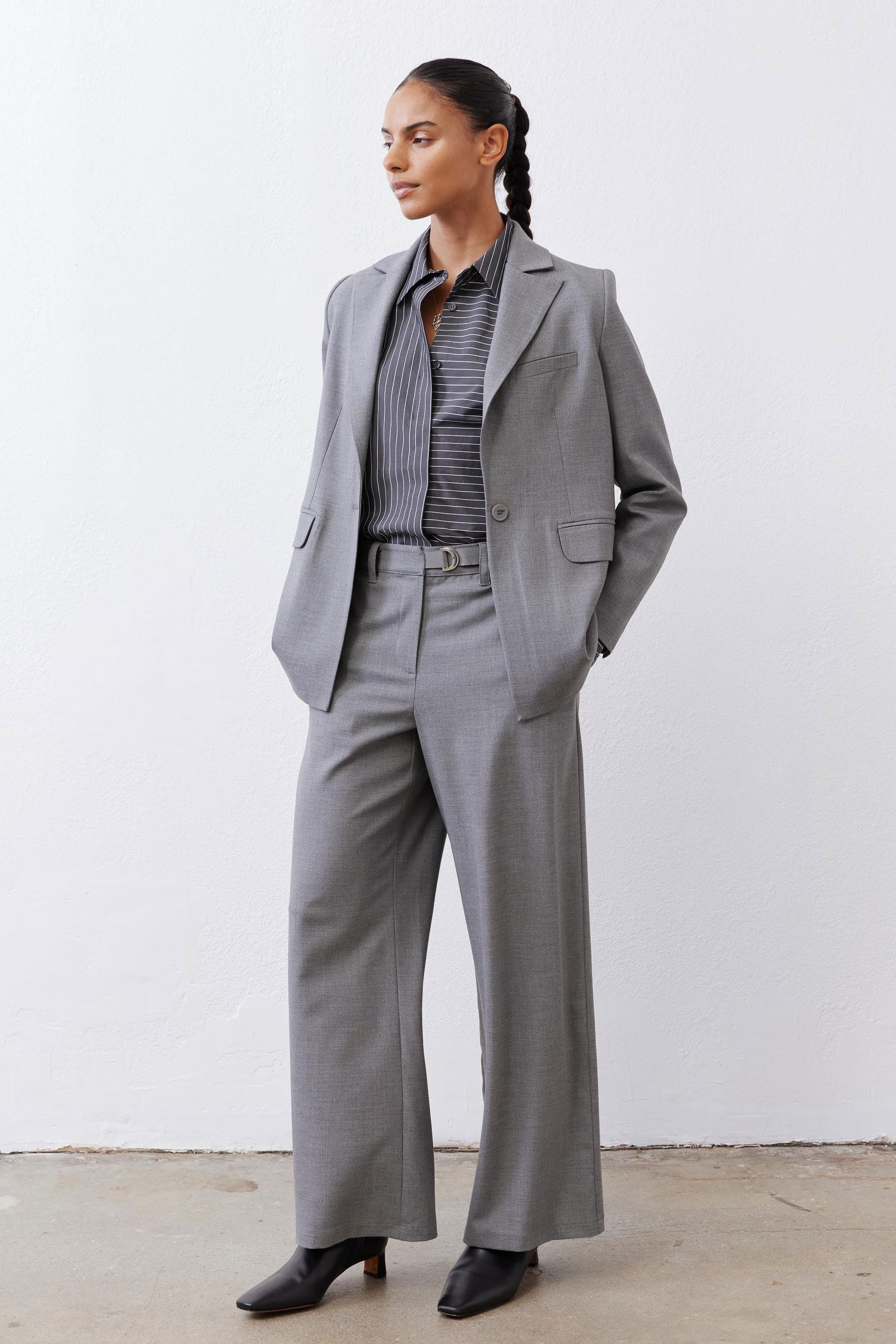 Gray-and-white striped button-down blouse collar peeking under gray jacket