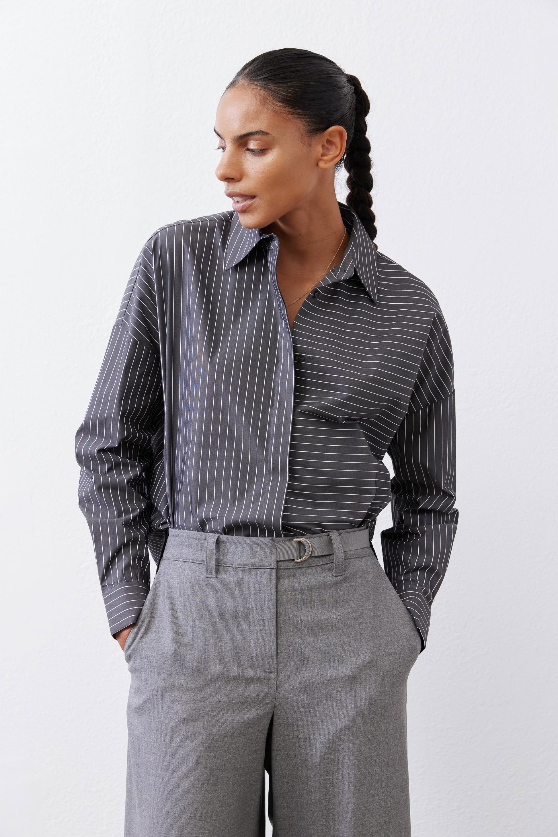 Close-up of gray-and-white striped button-down blouse with button front and collar