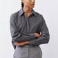Striped button-down blouse with long sleeves, button cuffs, and pointed collar