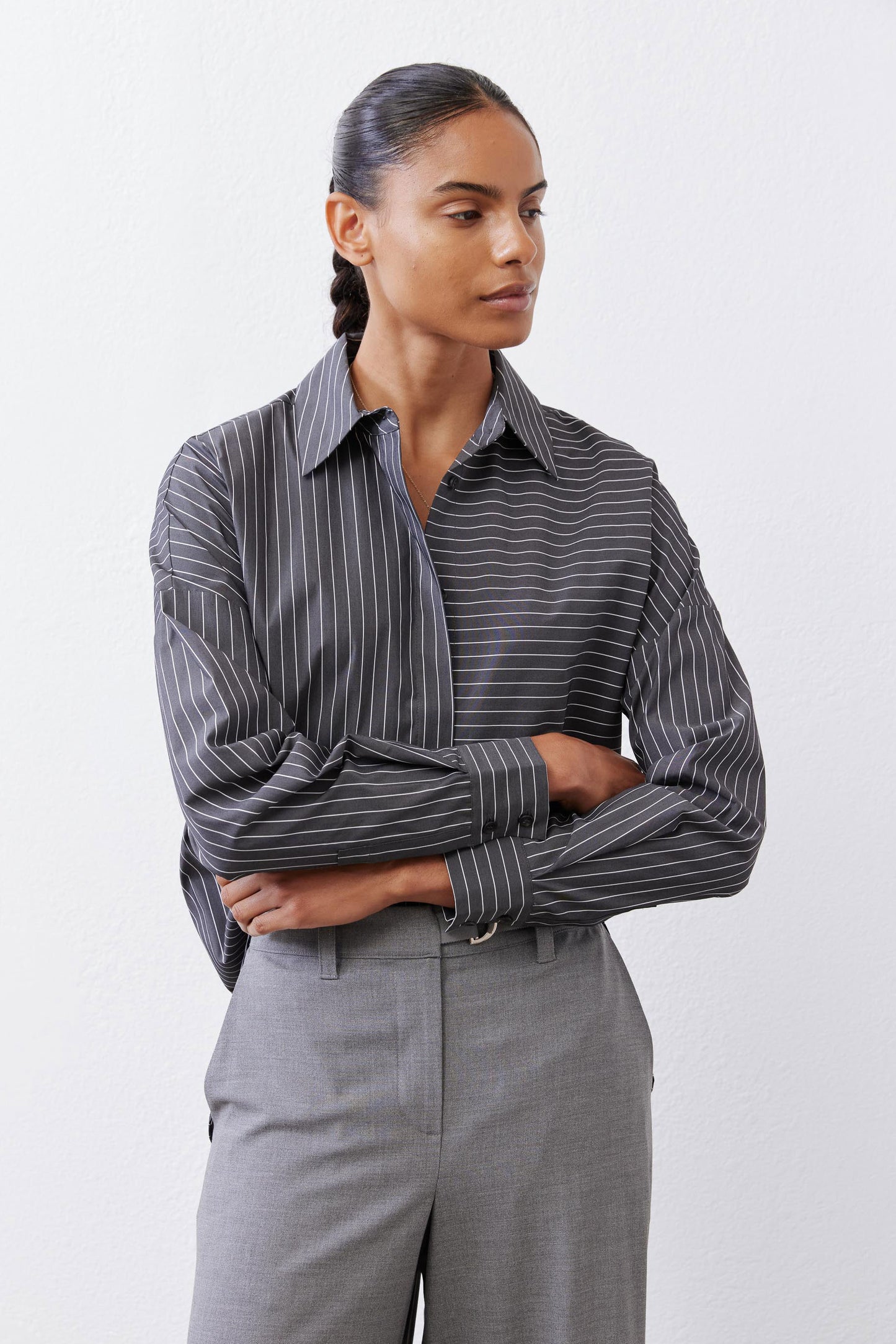 Striped button-down blouse with long sleeves, button cuffs, and pointed collar