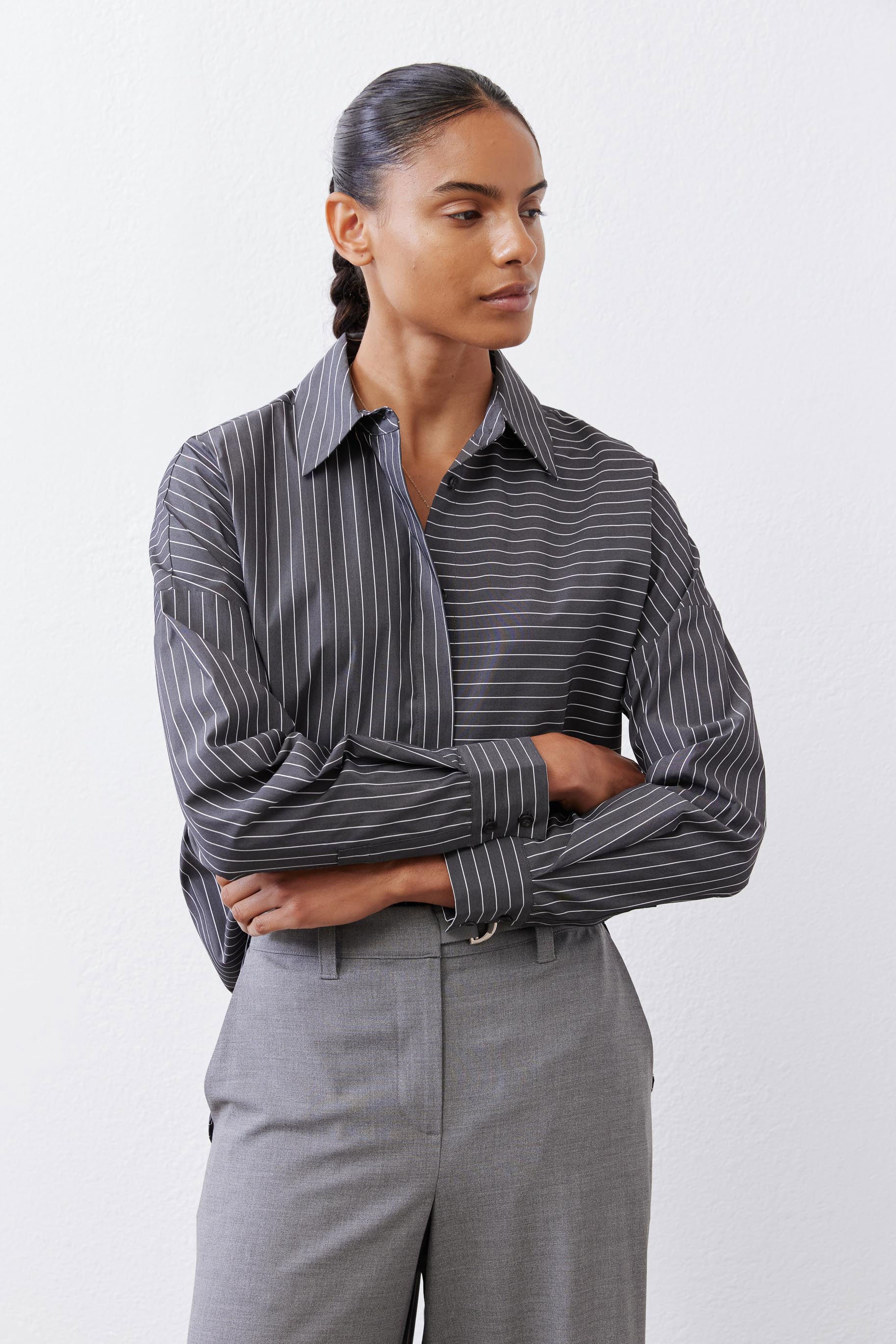 Striped button-down blouse with long sleeves, button cuffs, and pointed collar