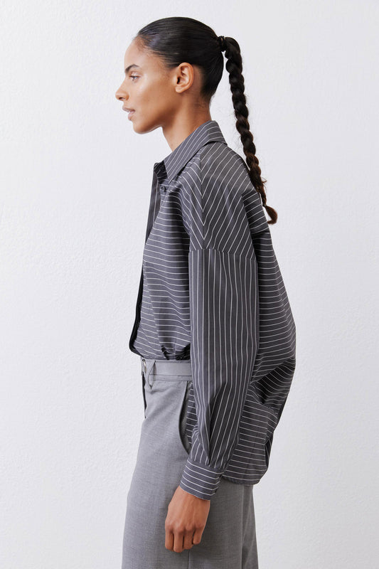 Gray-and-white striped button-down blouse, side view with long sleeves