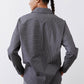 Back view of gray-and-white striped button-down blouse with long sleeves