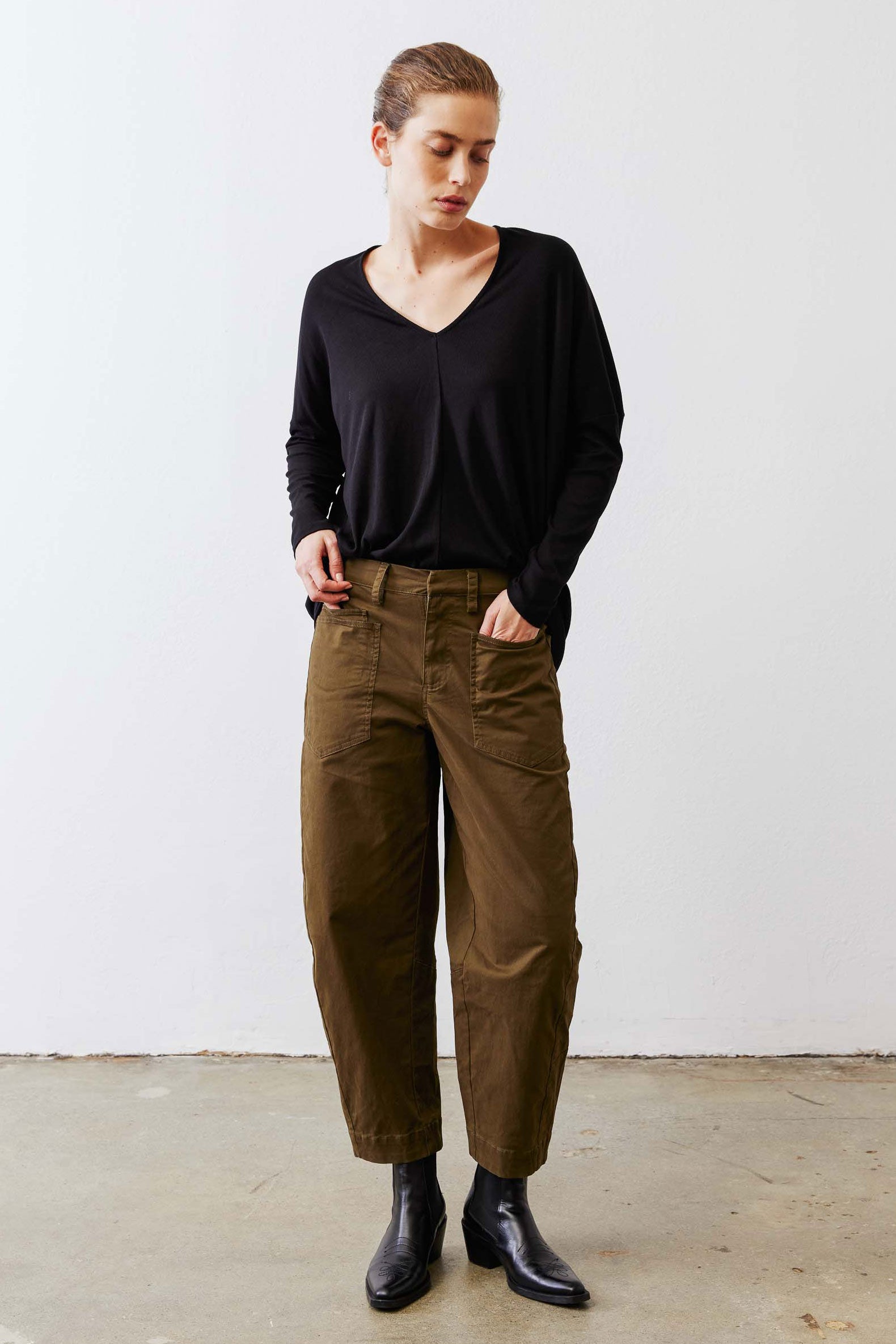Black ribbed dolman long sleeve top with V-neck and loose, draped shoulders